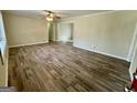 Open living room showcasing hardwood floors, neutral walls, and an open doorway leading to another room at 2228 Headland Dr, East Point, GA 30344