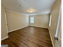 Large bedroom features wood floors, light walls, and natural light at 2430 Fern Valley Ct, East Point, GA 30344