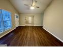 Open-concept living room with hard surface floors and ample space for a variety of furniture arrangements at 890 Old Rocky Rd, Atlanta, GA 30349