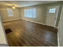 Bright living room with wood-look flooring and natural light streaming through the windows at 645 Steve Sw Dr, Atlanta, GA 30315