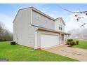 Well-maintained two-story home with a two-car garage, side entry, and manicured green lawn at 415 Arthurs Ln, Covington, GA 30016