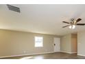 Bright living room featuring a ceiling fan and clean, neutral-colored walls at 430 Birch Se Ln, Conyers, GA 30094