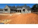 Beautiful gray single-story home with black accents, inviting entrance, and landscaping potential at 505 Discovery Lake Dr # 405, Fayetteville, GA 30215