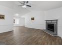 Open-concept living space with wood floors, neutral paint, and a cozy fireplace at 321 Pleasant Valley Rd, Mcdonough, GA 30253