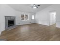 Spacious living room featuring a fireplace, ceiling fan, and natural light at 321 Pleasant Valley Rd, Mcdonough, GA 30253