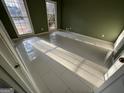 Bright bedroom showcasing white tiled floor and sunlit windows at 1241 Mount Vernon Dr, Lawrenceville, GA 30044