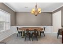 Elegant dining room with a beautiful chandelier and a rustic wooden table at 45 George Wynn Rd, Palmetto, GA 30268