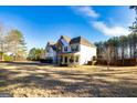 Two-story home with stone accents, white siding, and a spacious front lawn at 45 George Wynn Rd, Palmetto, GA 30268