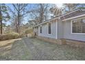 Charming home featuring a brick pathway and light blue siding at 6187 Radford Dr, Riverdale, GA 30296