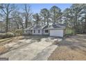 Well-maintained single-level house with attached garage and a long driveway at 6187 Radford Dr, Riverdale, GA 30296