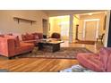 Bright and airy living room with hardwood floors, a large sectional sofa, and an open layout at 35 Abelia Dr, Covington, GA 30014