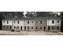Row of new townhomes with mixed exterior finishes, set on a gravel lot at 7262 Crestside Dr # 67, Austell, GA 30168