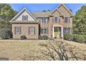 Attractive brick home with a manicured front yard and a vibrant green front door at 44 Willow Leaf Way, Sharpsburg, GA 30277