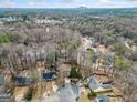 An aerial view showcasing a neighborhood with tree-lined streets and homes, offering a serene and community-oriented atmosphere at 5119 Hill Farm Ne Dr, Woodstock, GA 30188