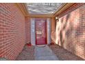 Welcoming brick entranceway featuring a storm door, decorative plants, and neutral colored welcome mat at 300 Planceer Pl, Peachtree City, GA 30269