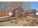 Brick home showing the side yard with a wood fence and a partial view of the attached garage at 300 Planceer Pl, Peachtree City, GA 30269