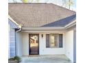 Close up of front entrance featuring a newer door and classic decorative shuttered window at 2768 Southpark Sw Blvd, Conyers, GA 30094