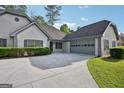Charming home with a manicured lawn, gray trim, a driveway, and an attached garage at 2768 Southpark Sw Blvd, Conyers, GA 30094