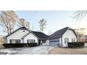 Charming home with a manicured lawn, gray trim, a driveway, and an attached garage at 2768 Southpark Sw Blvd, Conyers, GA 30094