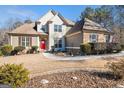 Charming two-story home with a red front door, well-kept landscaping, and a welcoming walkway at 6 Water Oak Dr, Sharpsburg, GA 30277