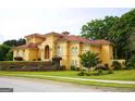 Elegant home with a red tile roof, arched windows, a manicured lawn, and sophisticated landscaping on a tiered front yard at 956 Shadowford Fls, Lithonia, GA 30058