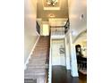 Inviting foyer with a staircase, hardwood floors, and elegant architectural details at 611 Winners Cir, Locust Grove, GA 30248