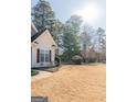 Inviting home exterior showcasing lush front lawn and mature trees at 104 Summer Chase, Carrollton, GA 30116