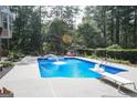 Sparkling in-ground pool with diving board and a gazebo providing shade and relaxation at 8179 Pineview Ct, Villa Rica, GA 30180