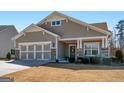 Charming single-story home featuring a two-car garage, covered porch, and neutral siding in a well-maintained community at 645 Timberbrook Dr, Sharpsburg, GA 30277