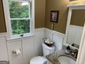 Charming half bathroom featuring white wainscoting and granite countertop at 281 Timber Laurel Ln, Lawrenceville, GA 30043