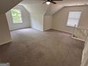 Spacious bonus room features vaulted ceiling, ceiling fan, carpet and two windows for ample light at 281 Timber Laurel Ln, Lawrenceville, GA 30043