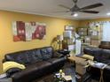 Cozy living room with leather sofas and decorative artwork on yellow walls at 281 Timber Laurel Ln, Lawrenceville, GA 30043