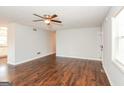 Open living room featuring hardwood floors, neutral paint, and a ceiling fan at 117 Parkway Ct, Dallas, GA 30157