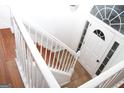 Bright entryway with tile flooring, white door and decorative transom window and wood staircase at 1630 Versailles Sw Dr, Atlanta, GA 30331