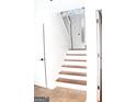 Inviting entryway showcasing a white door with transom window, wood stairs and tile flooring at 1630 Versailles Sw Dr, Atlanta, GA 30331