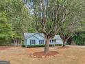 Quaint light blue home with manicured lawn and inviting front porch at 220 Melrose Way, Mcdonough, GA 30252