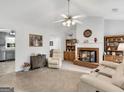 Cozy living room featuring a brick fireplace, plush seating, and neutral decor at 220 Melrose Way, Mcdonough, GA 30252