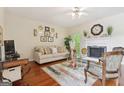 Inviting living room with a fireplace, hardwood floors, and neutral decor at 260 Millbrook Village Dr, Tyrone, GA 30290