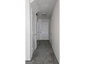 Hallway with gray carpet leading to white doors, offering a bright and neutral interior at 905 Pine Tree Trl, South Fulton, GA 30349