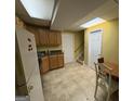 An eat-in kitchen features cabinets, countertop, sink, appliances and a door to the stairway at 24 Picketts Mill Pl, Acworth, GA 30101