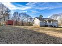 Expansive backyard featuring a storage shed, playset and plenty of space for recreation at 550 Stateline Rd, Bowdon, GA 30108