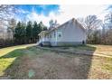 Beautiful backyard view featuring grassy yard, mature trees and a well maintained home at 550 Stateline Rd, Bowdon, GA 30108