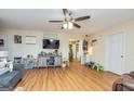 Bright living room with hardwood floors, ceiling fan, and plenty of natural light at 550 Stateline Rd, Bowdon, GA 30108