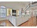 Bright living room with a fireplace, built-in shelving, hardwood floors, and staircase at 115 Ashton Park, Peachtree City, GA 30269