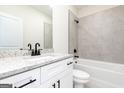 Elegant bathroom with granite countertop, white vanity, and a tiled shower-tub combo at 3372 Arabian Farm Ln, Dacula, GA 30019