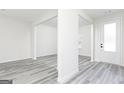 Open living area with light gray flooring and white walls, illuminated by natural light at 3413 Arabian Farm Ln, Dacula, GA 30019