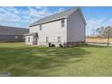 View of the home's back exterior and a large, green backyard at 3402 Arabian Farm Ln, Dacula, GA 30019