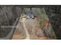 Aerial view of a secluded home with a long driveway surrounded by mature trees, showing property lines at 172 Sam Solomon Rd, Locust Grove, GA 30248
