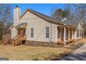 Charming single-story home with a covered front porch, wood shutters and beautiful landscaping at 3725 Concord Rd, Newborn, GA 30056