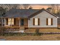 Charming single-story home with a covered front porch and beautiful landscaping at 3725 Concord Rd, Newborn, GA 30056